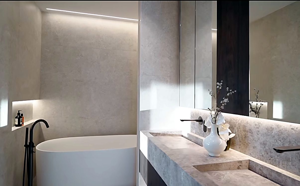 Stone-look bathroom renovation with freestanding bath and double vanity