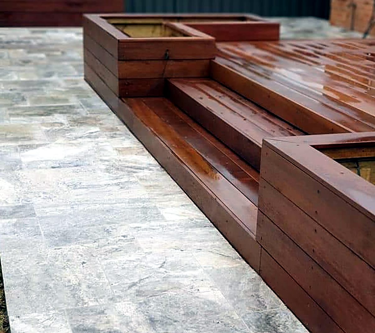 Merbau deck with planter boxes and travertine paving